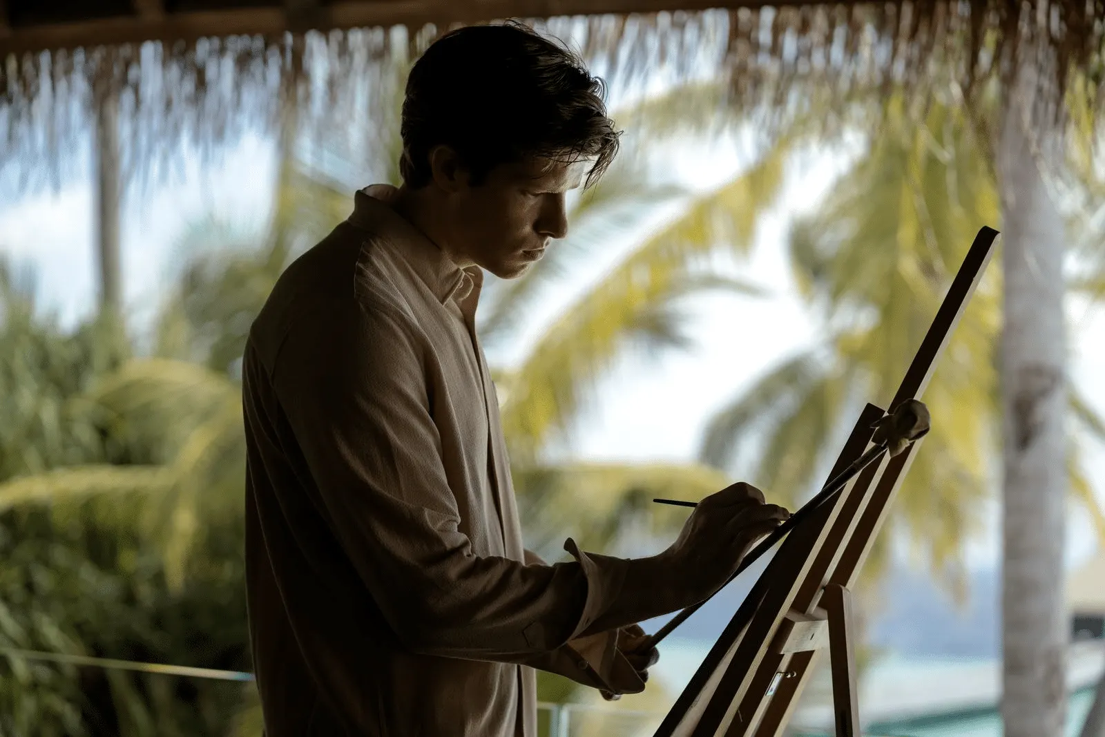 Artist painting at an easel