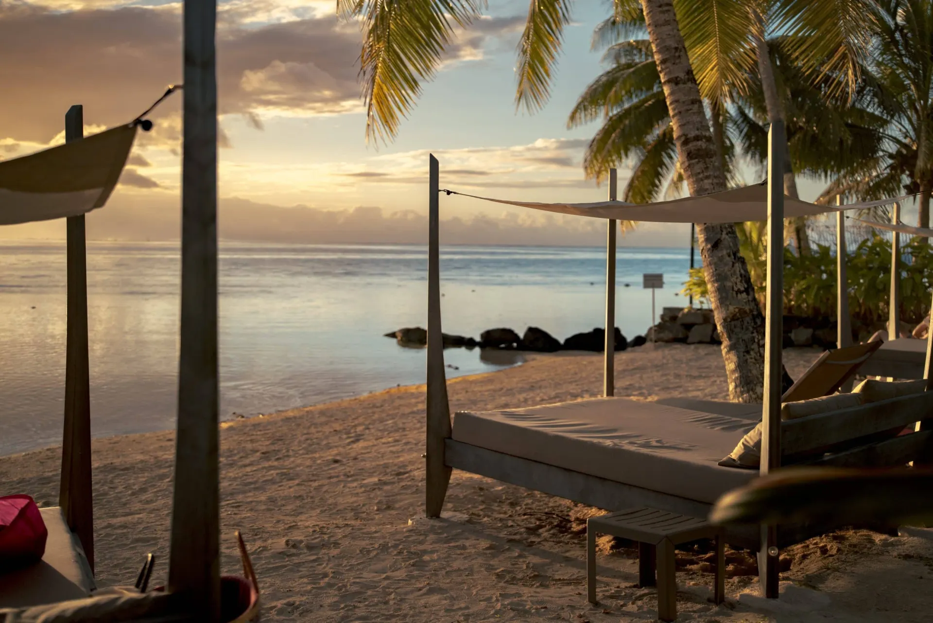Balinese bed on the beach at sunset